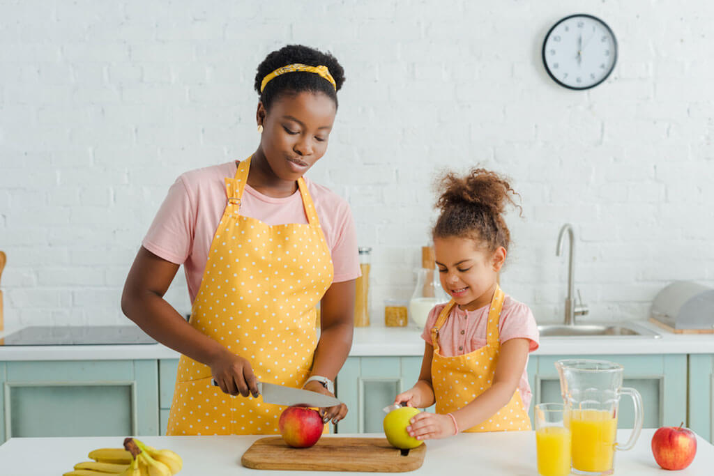 Mom and daughter cutting apples