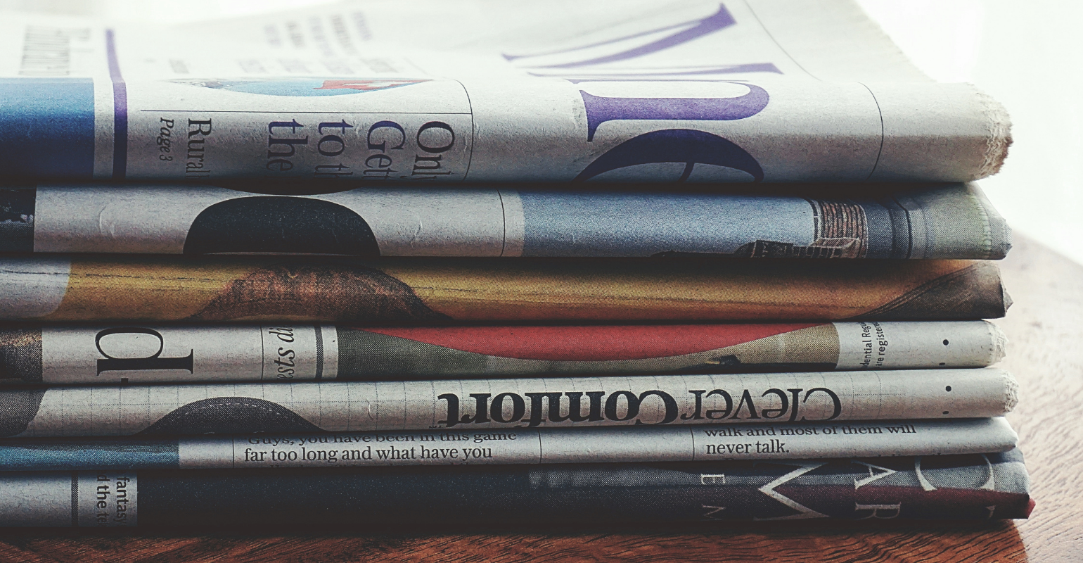 A tall stack of newspapers.